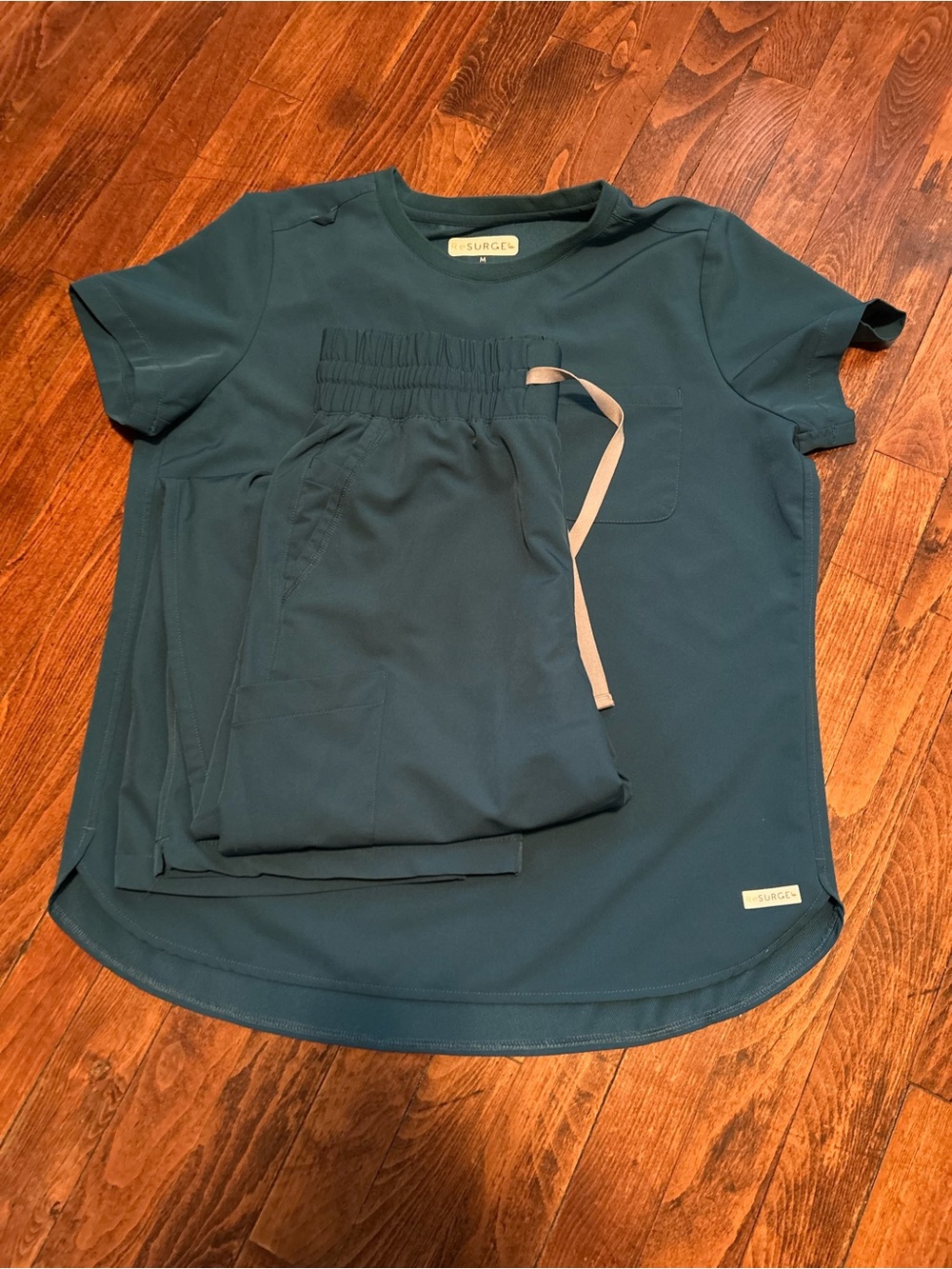Resurge crew neck tuck in top and 7 pocket wide leg scrubs in Caribbean blue
